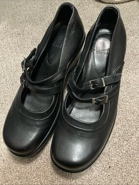 Dansko Mary Janes feature a distinctive double-strap buckle design